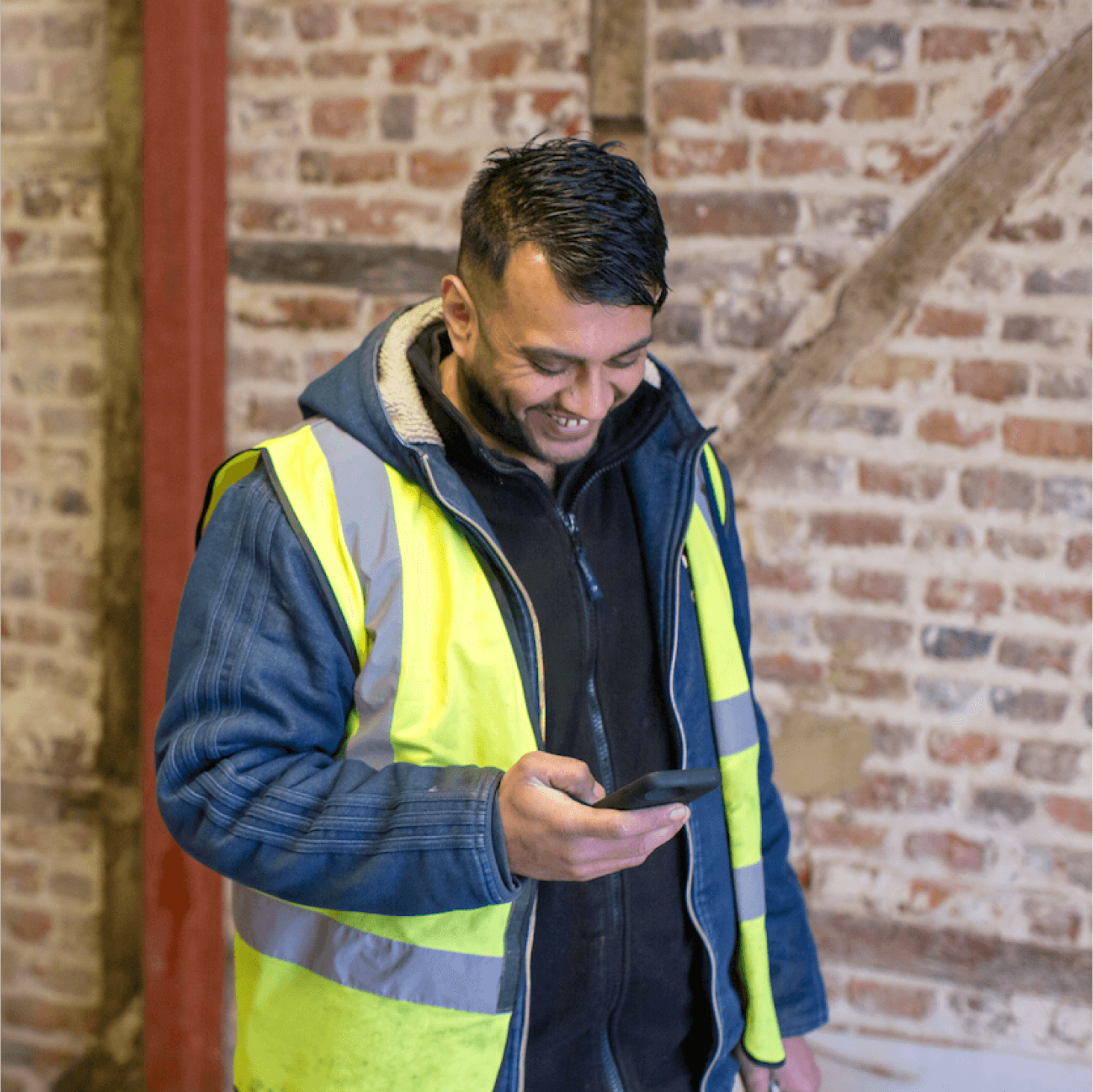 A builder checks the money side of things using the Xero accounting app on their phone.