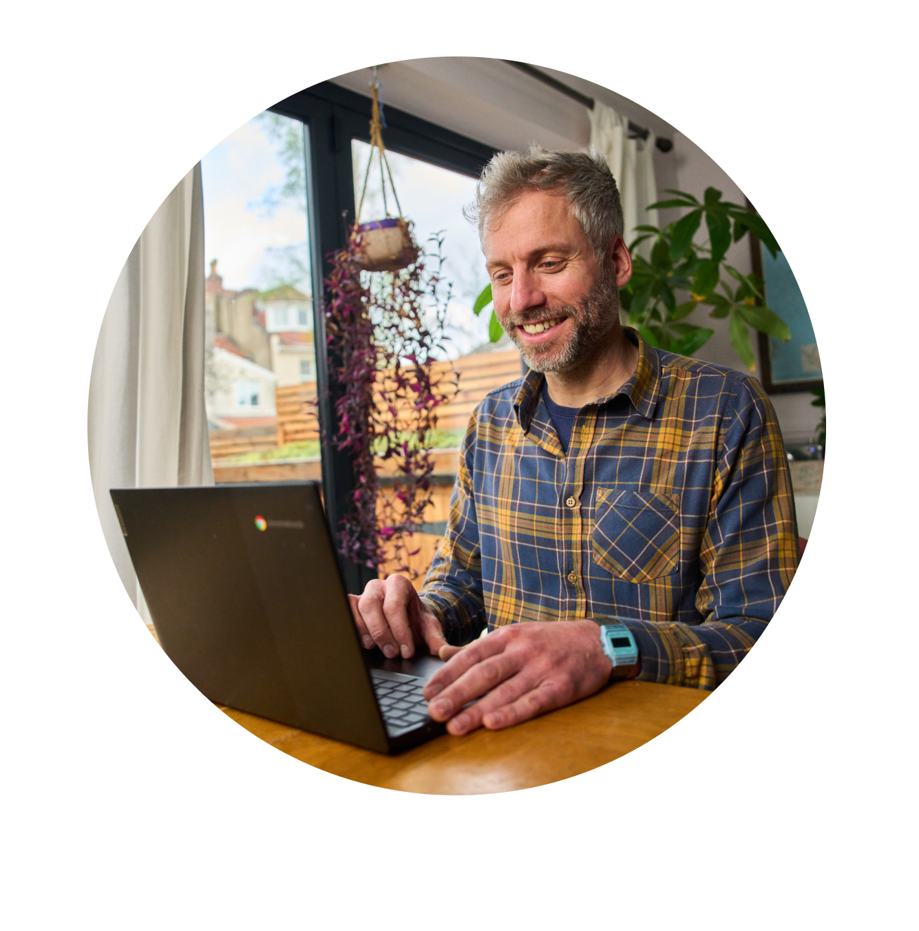 Man in shirt looking at his laptop